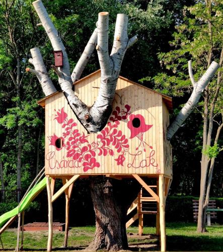 a tree house in the middle of a tree at Tassi Halászcsárda-Harcsa ház in Tass