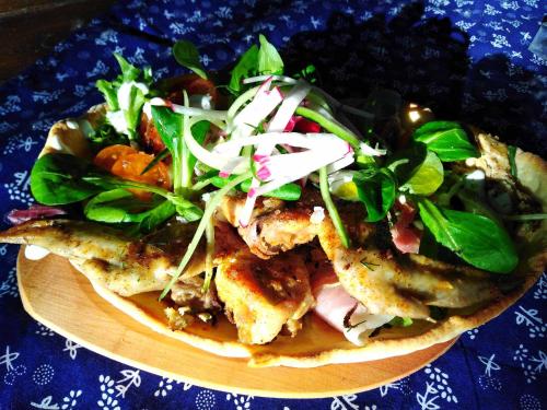 a plate of food with a salad on a table at Tassi Halászcsárda-Harcsa ház in Tass