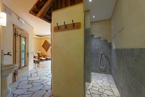 a bathroom with a shower and a toilet and a sink at Villa Ortensia in San Vigilio Di Marebbe