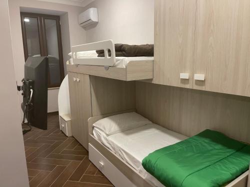 a small room with two bunk beds and a camera at Casa Meravigliosa Fonseca in Naples