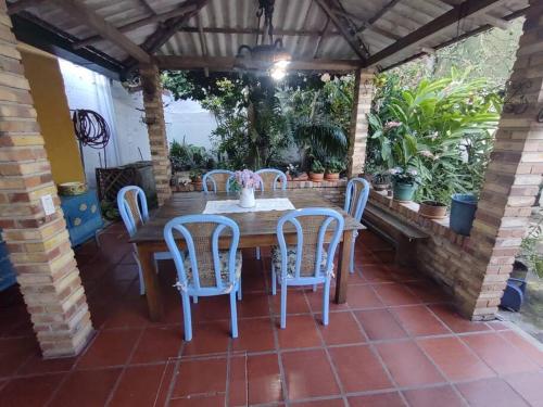 a wooden table and chairs on a patio at Villa Isabel in Guaduas