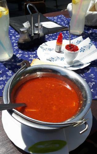 a pot of soup sitting on a table at Tassi Halászcsárda-Harcsa ház in Tass