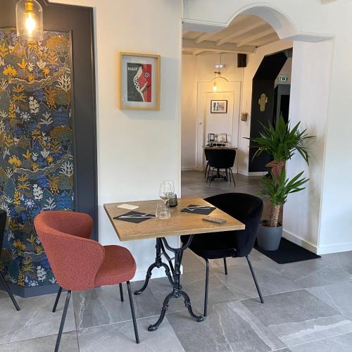 a dining room with a table and two chairs at Le Clos Du Pontic Logis et Cit'Hotel in Landerneau