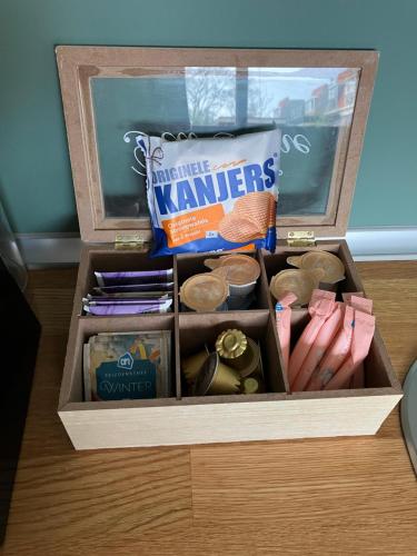a wooden box filled with items on a table at De Haarlemse Logeerkamer in Haarlem