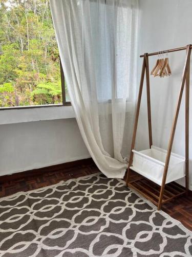 a room with a swing and a window at lily maison in Tanah Rata