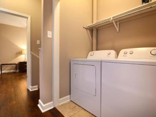 a laundry room with two sinks on a shelf at Large Condo in Downtown Memphis in Memphis