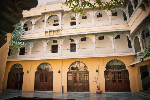 an old building with many doors and windows at The Fern Bambora Fort, Bambora, Udaipur in Udaipur