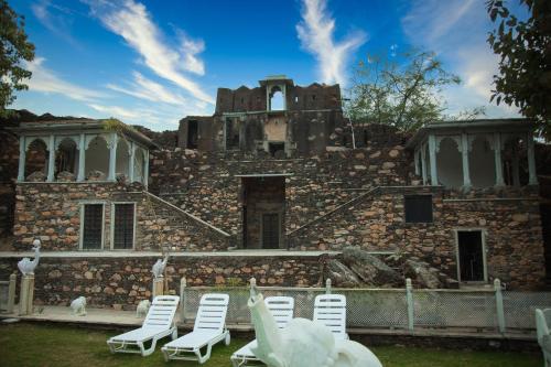 a group of chairs sitting in front of a building at The Fern Bambora Fort, Bambora, Udaipur in Udaipur