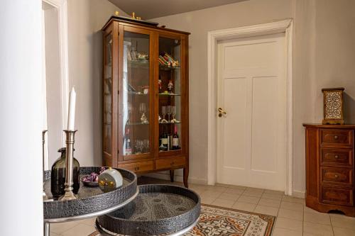 a living room with a glass cabinet and a table at Althaia Pension in Nafplio