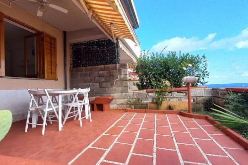 a patio with a table and chairs on a house at Margherita sul mare - 250 m from the beach in Porto San Giorgio