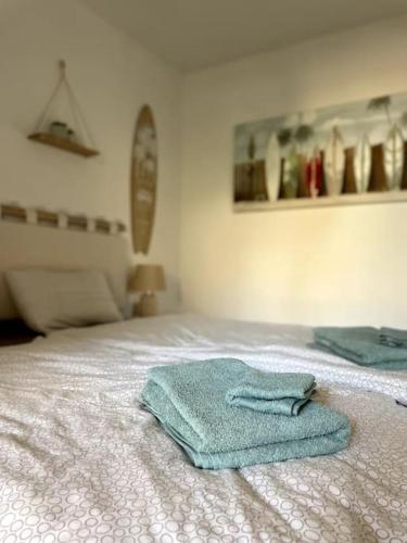 a pair of towels sitting on top of a bed at SurfPartment Deluxe in La Pared