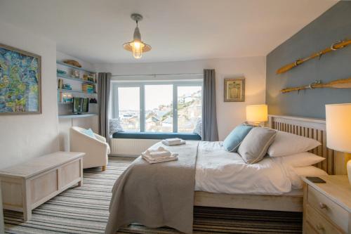 a bedroom with a bed and a window at Cormorant- Sea View, Couples Retreat in Brixham