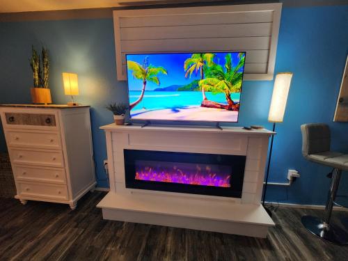 a living room with a tv and a fireplace at Landmark 830 in Myrtle Beach