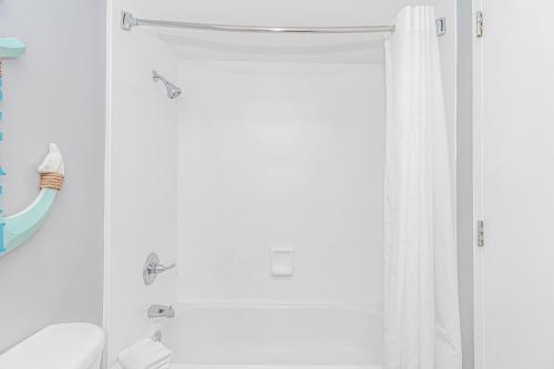 a bathroom with a shower curtain and a toilet at Landmark 830 in Myrtle Beach