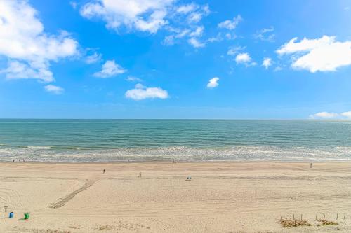 a beach with people on the sand and the ocean at Landmark 830 in Myrtle Beach
