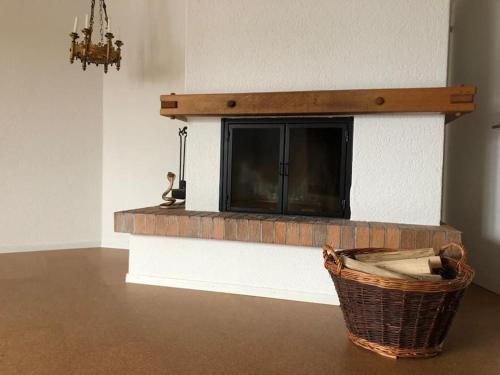 a living room with a brick fireplace with a tv at Wohnung in Burgdorf beim Schloss in Burgdorf