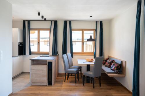 Una cocina con una mesa y sillas en una habitación. en Himml Schlosshof, en Umes