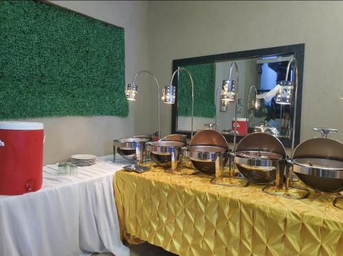 a table with bowls and pans on top of it at Palazzo 1 HotSpring,3Bedrooms 35to40pax, Pansol Calamba in Pansol