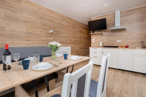 a kitchen and dining room with a table and chairs at Cozy studio in Downtown Gdańsk by Renters in Gdańsk