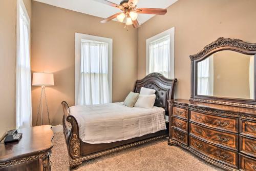 a bedroom with a bed and a dresser and a mirror at Bright Apartment, Near Vicksburg Military Park! in Vicksburg