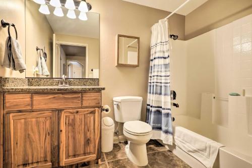 a bathroom with a toilet and a sink and a shower at Home with Yard and ATV Access to Sand Hollow State Park! in Hurricane
