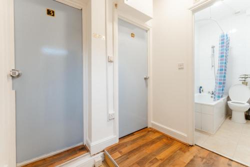 a bathroom with a toilet and a sink at Upton Park Bedrooms 25 min to Central London in London