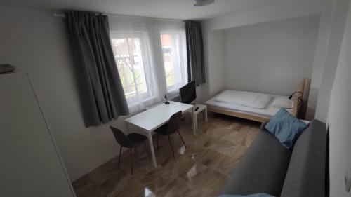 a small room with a table and chairs and a window at Vila Gajdo in Tvrdošovce