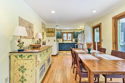 a dining room with a table and a kitchen at Cozy Monterey Home with Porch Walk to Lake Garfield in Monterey