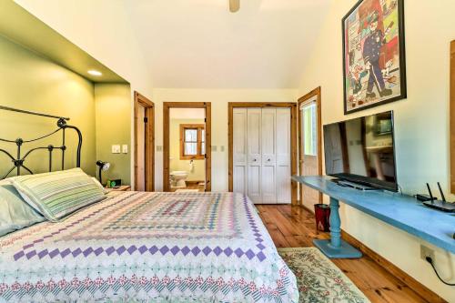 a bedroom with a bed and a blue counter at Cozy Monterey Home with Porch Walk to Lake Garfield in Monterey