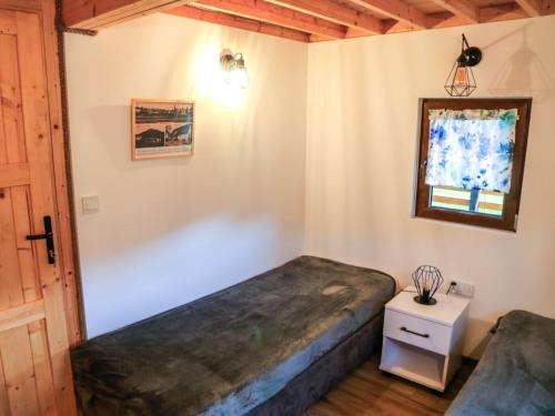 a bedroom with a bed and a window and a table at W Dolinie Bobru in Trzcińsko