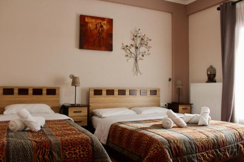 a hotel room with two beds with towels on them at Guesthouse Alexandros in Pýli