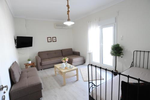 a living room with a couch and a table at Memories... in Iraklitsa