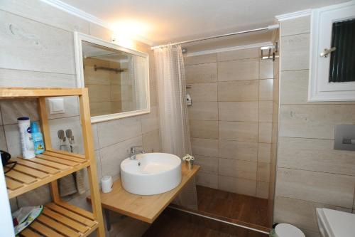 a small bathroom with a sink and a shower at Memories... in Iraklitsa
