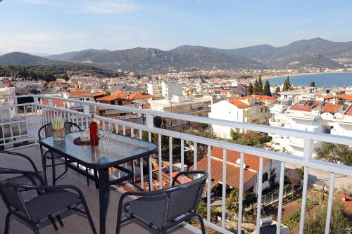 a table and chairs on a balcony overlooking a city at Memories... in Iraklitsa