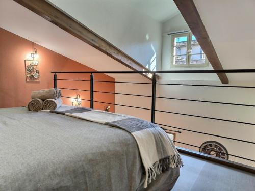 a bedroom with a large bed in a attic at Le Coquelicot - Hyper-Centre - Wifi - Calme in Albi