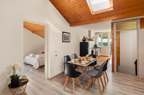 a kitchen and dining room with a table and chairs at Villa Paradiso: Near beach, superb pool and garden in Astrakeri