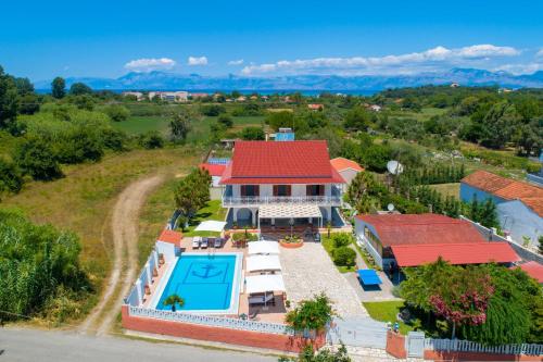 an aerial view of a house with a swimming pool at Villa Paradiso: Near beach, superb pool and garden in Astrakeri