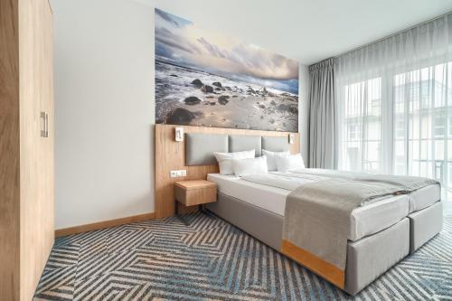 a bedroom with a large bed and a large window at Afrodyta Spa in Świnoujście