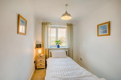 a small bedroom with a bed and a window at 44 West Front Road in Bognor Regis