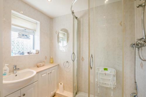 a bathroom with a shower and a sink at 44 West Front Road in Bognor Regis