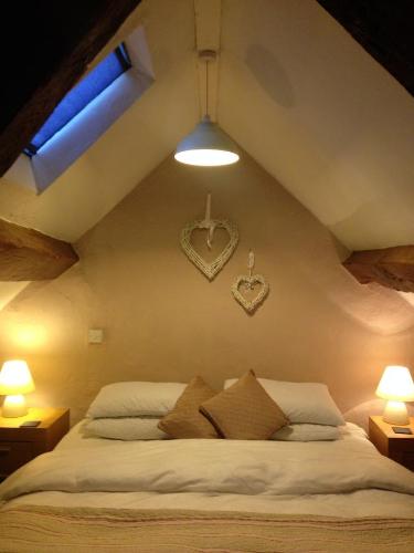 a bedroom with a bed with two hearts on the wall at Tyddyn Bach Barn in Betws-y-coed