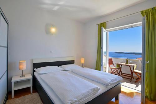 Un dormitorio con una cama con vista al mar. en Sunset apartments, en Hvar