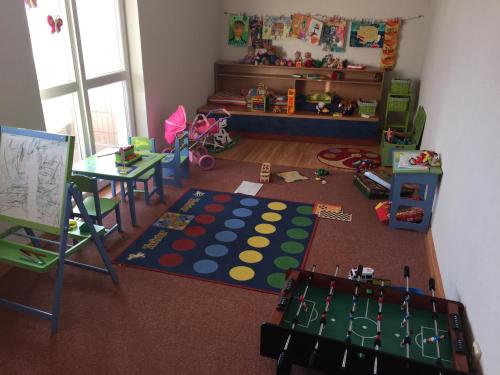 a childs room with a table and a play area at Tatra Hotel in Poprad