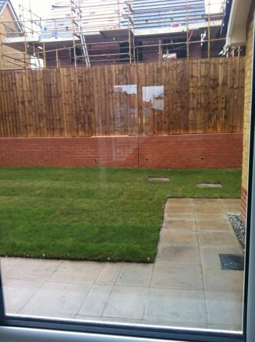 a window view of a yard with a fence at sen in Liverpool