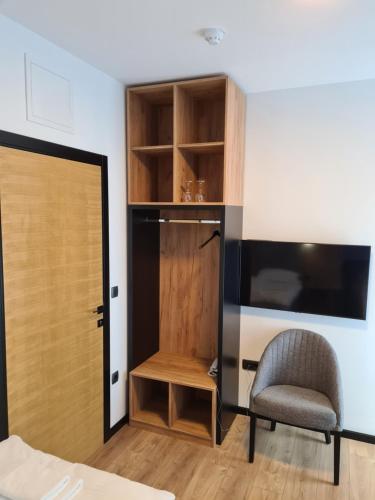 a room with a chair and a desk and a door at Motel BTG in Tomislavgrad