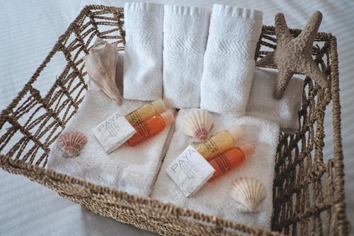 a basket filled with towels and seashells and towels at Smugglers Cove Inn in Lunenburg