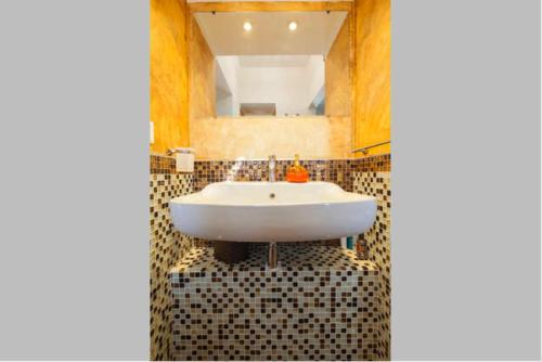 a bathroom with a white sink and a mirror at Atrani House-AMALFI in Atrani