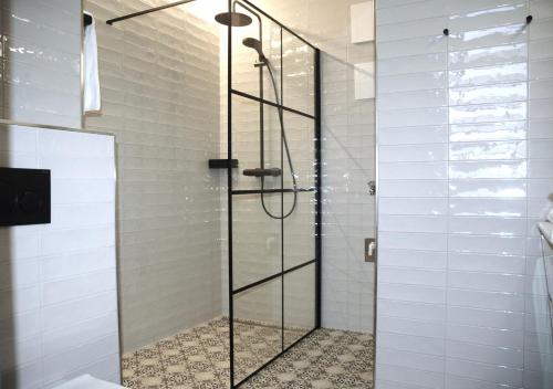 a shower with a glass door in a bathroom at Apartmenthaus Ahorn in Mittelberg