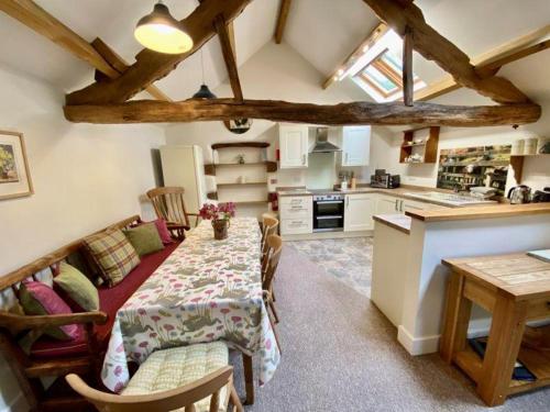 a kitchen and dining room with a table in a room at Stunning barn minutes from the Lake District in Penrith