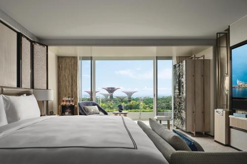 a bedroom with a large bed and a view of singapore at Marina Bay Sands in Singapore